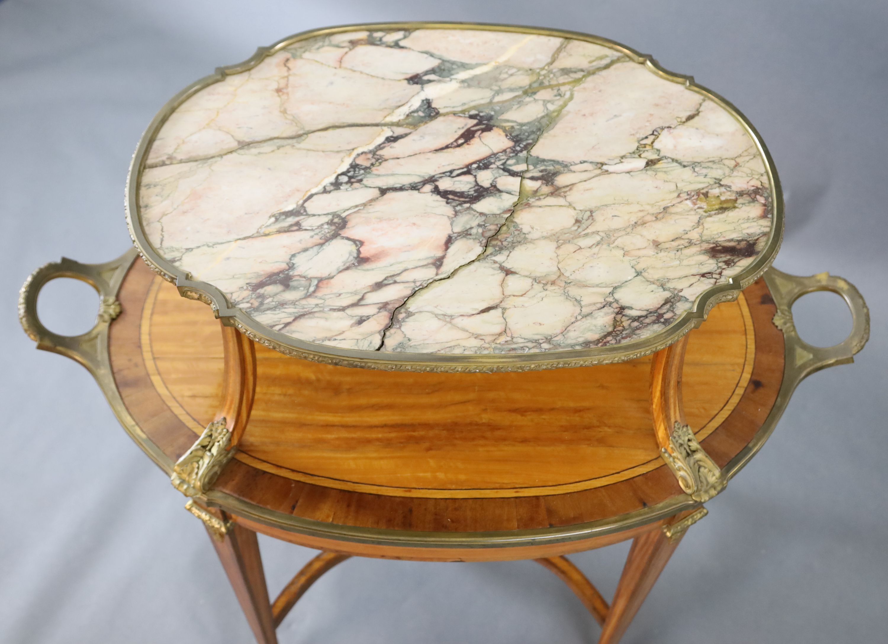 A late 19th century French satinwood, rosewood crossbanded and gilt metal mounted two tier oval etagere, W.3ft 4.5in. D.2ft H.3ft 3in.